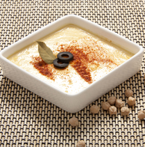 hummus in a white square bowl with toppings to add to your daily menu for a 3 year old- SuperKids Nutrition