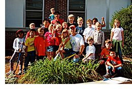 Joe the gardener planting with kids