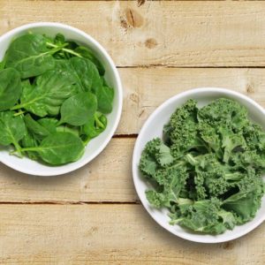 kale vs spinach image with both greens in bowls
