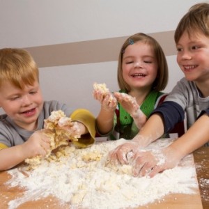 Kids making dough for baking christmas cookies