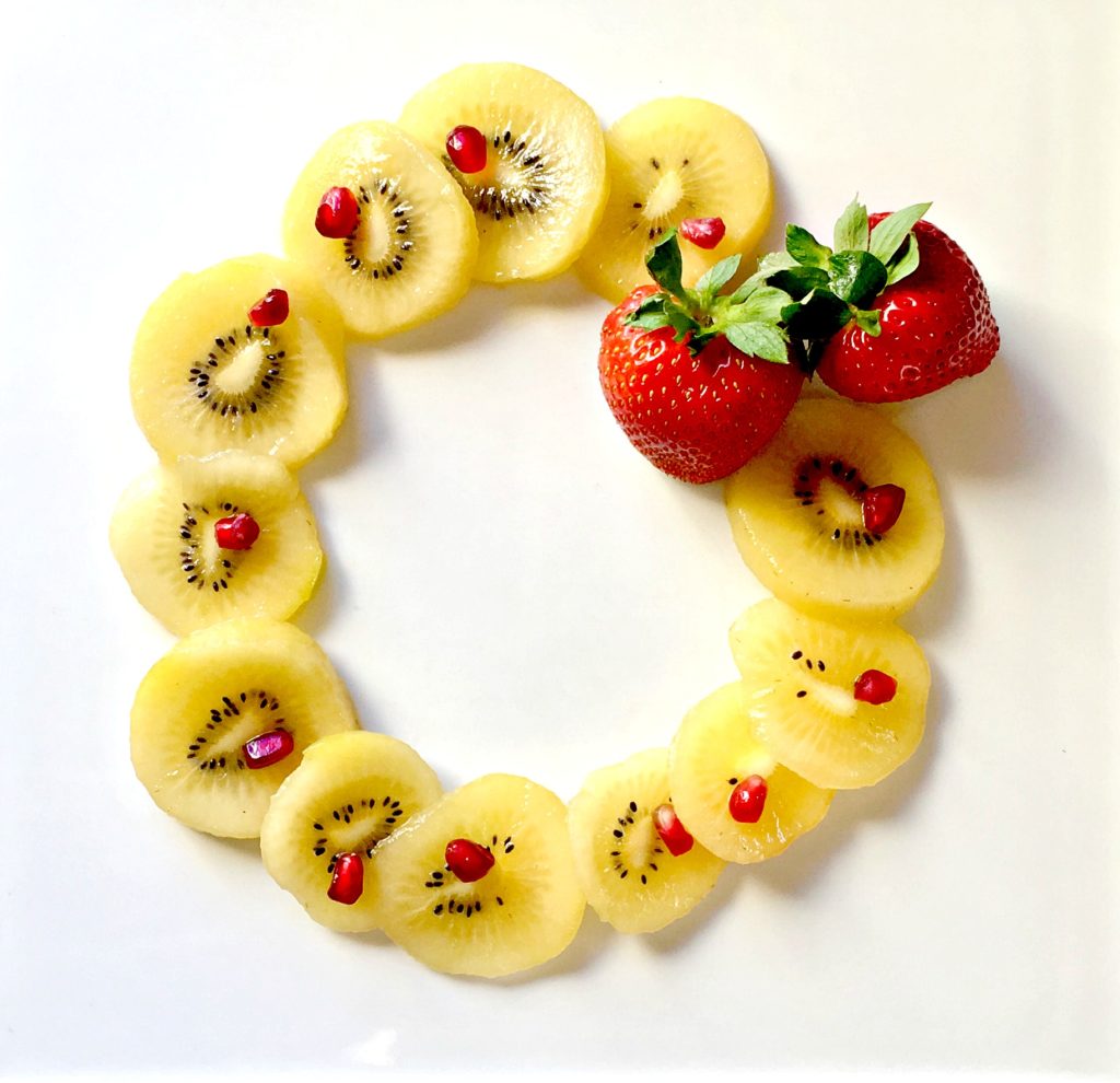 edible kiwi wreath with pomegranate for healthy holidays