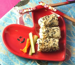 sushi on heart plate with veggies