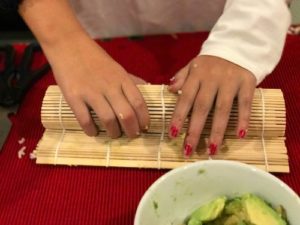 final step of rolling sushi in bamboo