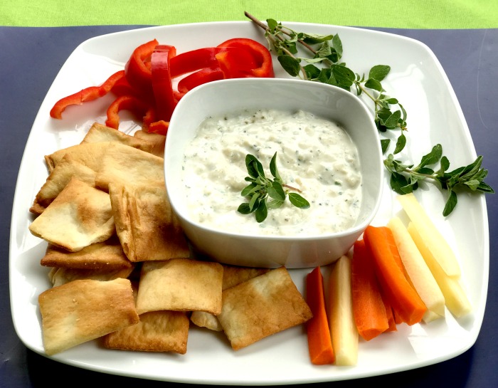 Tasty onion dip with peppers, carrots, and pita chips
