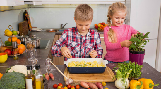kids cooking in the kitchen with vegetables and herbs, an idea for picky eaters - SuperKidsNutrition.com