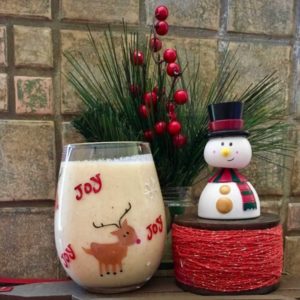 kiwifruit sungold eggnog with a small christmas tree and a snowman for a healthy holiday dessert