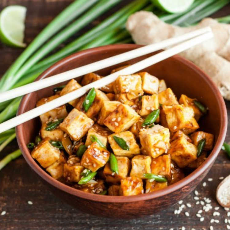 brown bowl with ginger honey tofu for holiday dish
