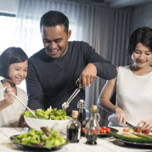 asian family cooking together making salads inside of sight (1)