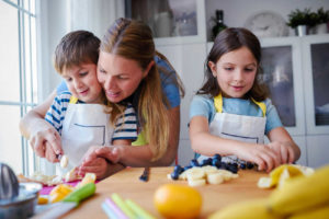 daughter and son cooking with mom fruits for inside article