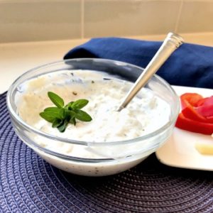 caramelized onion dip with veggie side on a purple placemat
