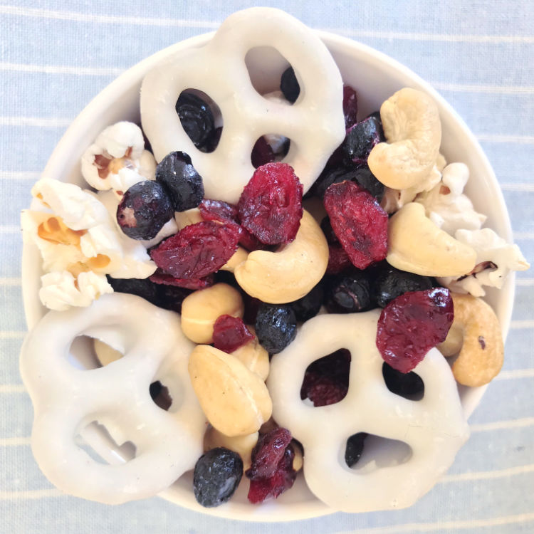 Red white and blue trailmix with cranberries, blueberries, pretzels, cashews, and popcorn