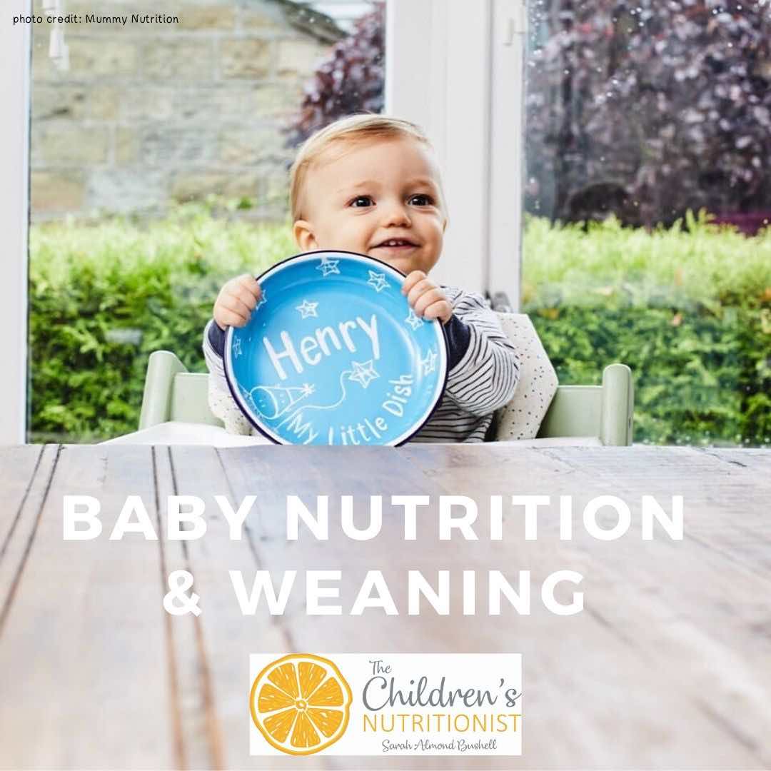 Baby boy with plate for baby nutrition and weaning course by nutritionist