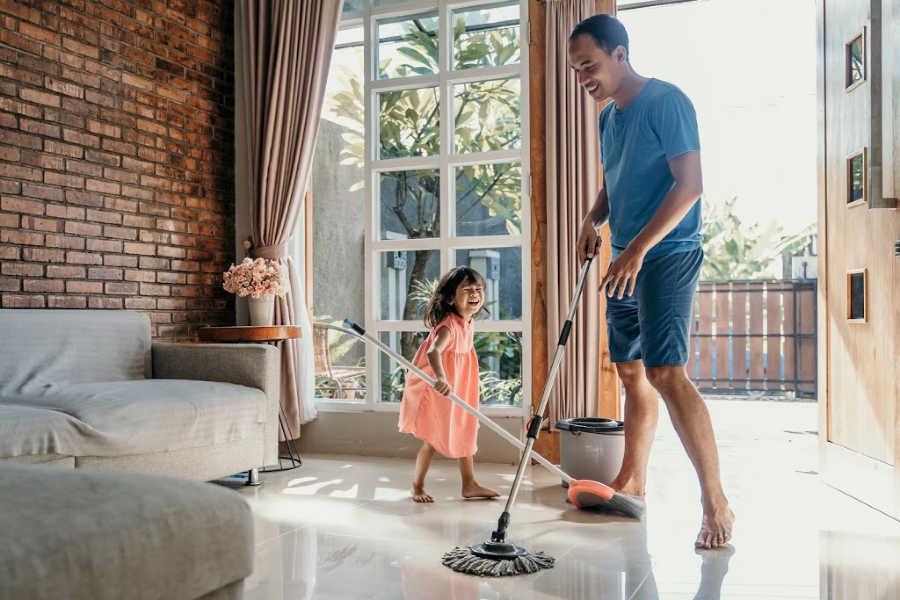 little girl help her daddy to do chores at home