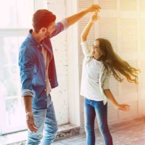 dad and daughter dancing at home