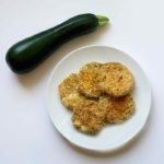 Crispy Baked Zucchini Chips on plate with whole zucchini
