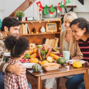 family sitting at table eating high fiber foods to prevent constipation in kids and adults