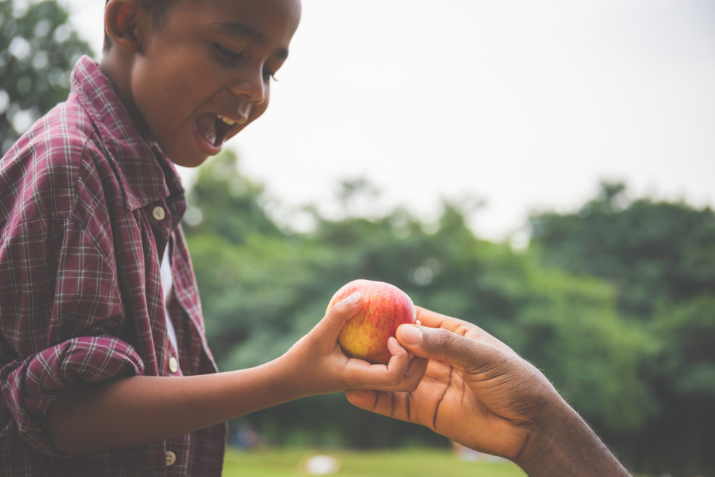 boy eating fresh fruit